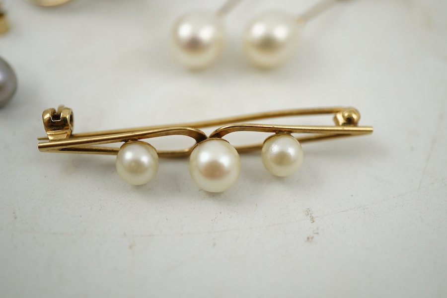A group of cultured pearl jewels, comprising: two pairs of cultured pearl drop earrings, longest 3cm, mounted in gold; and two cultured pearl brooches mounted in 9ct gold, longest 4.1cm, British hallmarks, combined gross